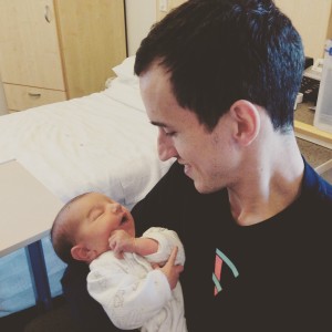 A picture of Red with his one week old son Lachlan.